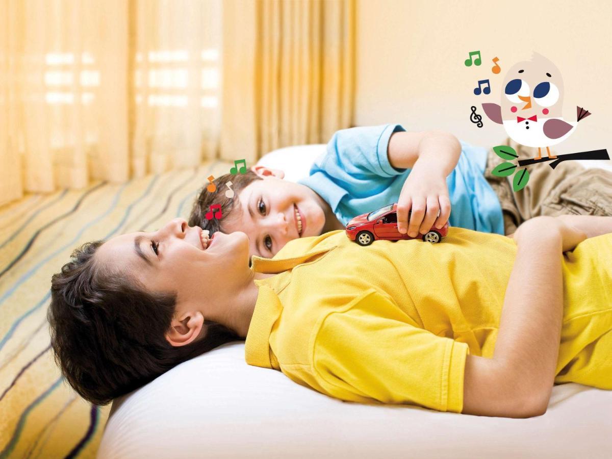Movenpick Jumeirah Village Triangle Дубай Екстериор снимка A child with autism playing with a toy car